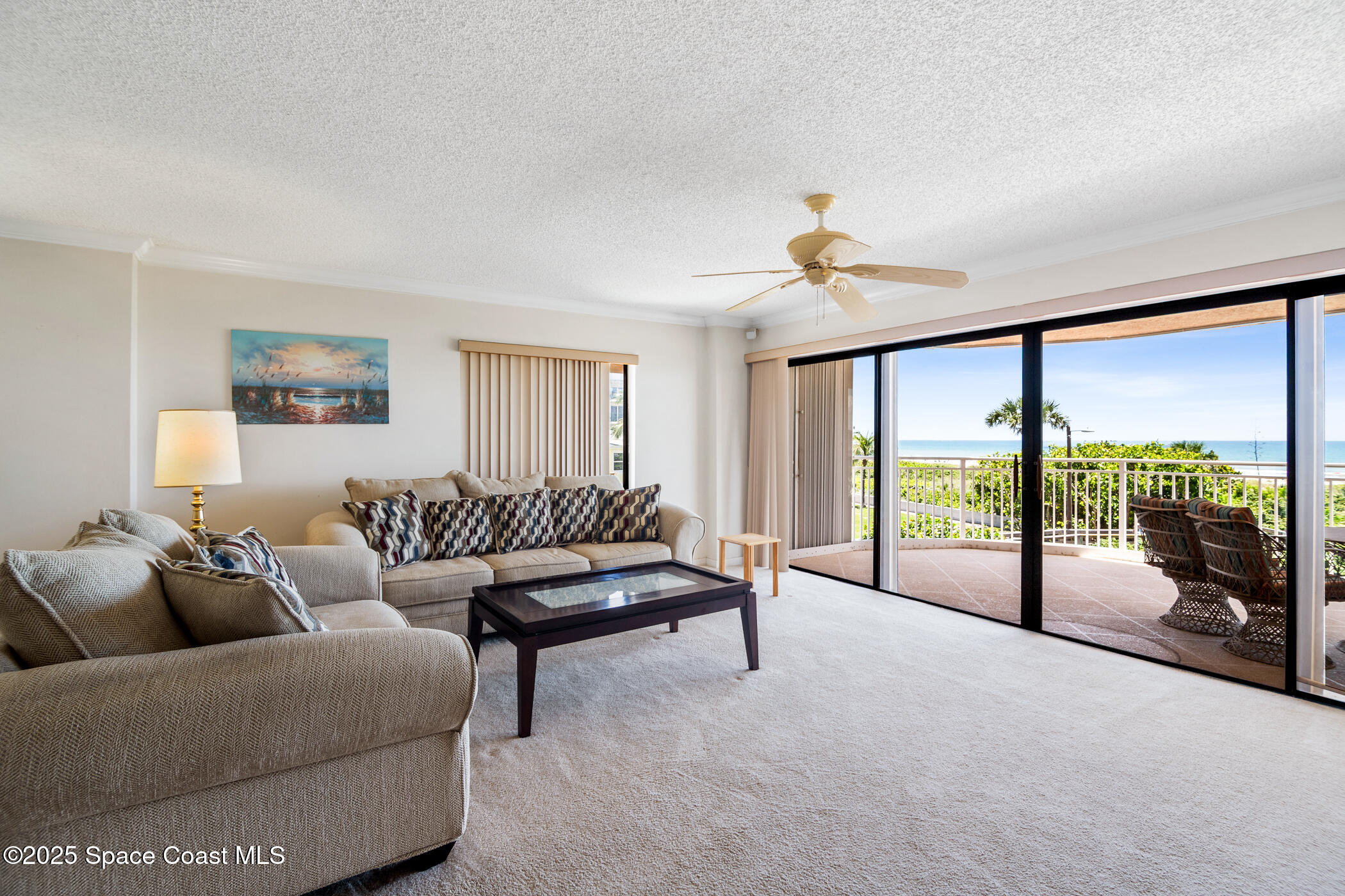 6770 Ridgewood Avenue, Unit 301 Cocoa Beach, FL 32931 - Photo 7 of 44 a living room with furniture and a large window with balcony view
