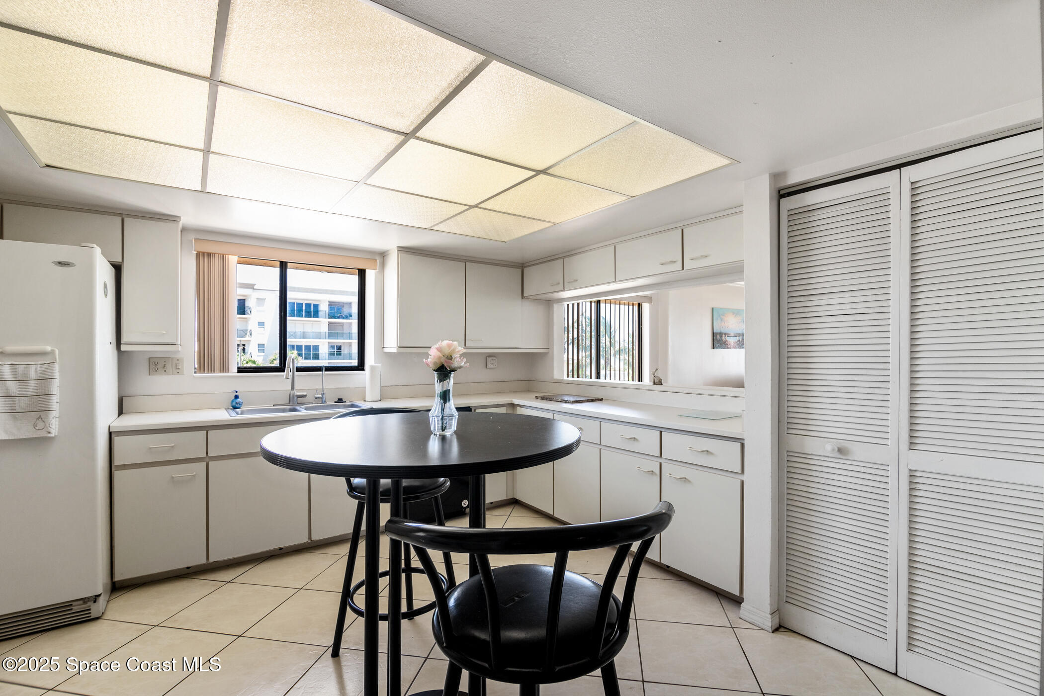 6770 Ridgewood Avenue, Unit 301 Cocoa Beach, FL 32931 - Photo 10 of 44 a kitchen with stainless steel appliances a sink stove and refrigerator