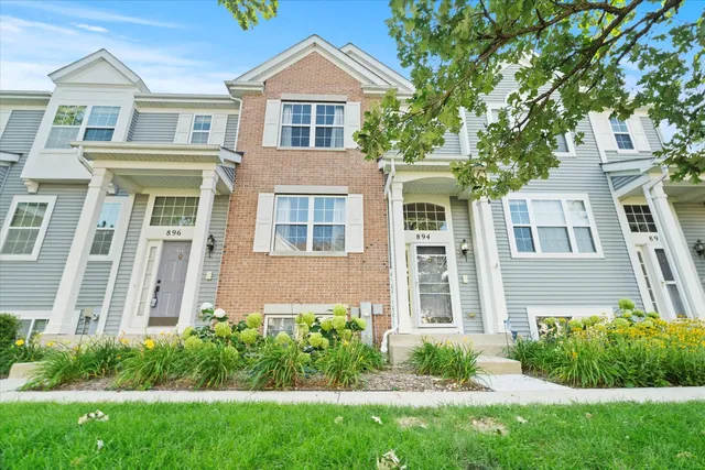 front view of a house next to a yard