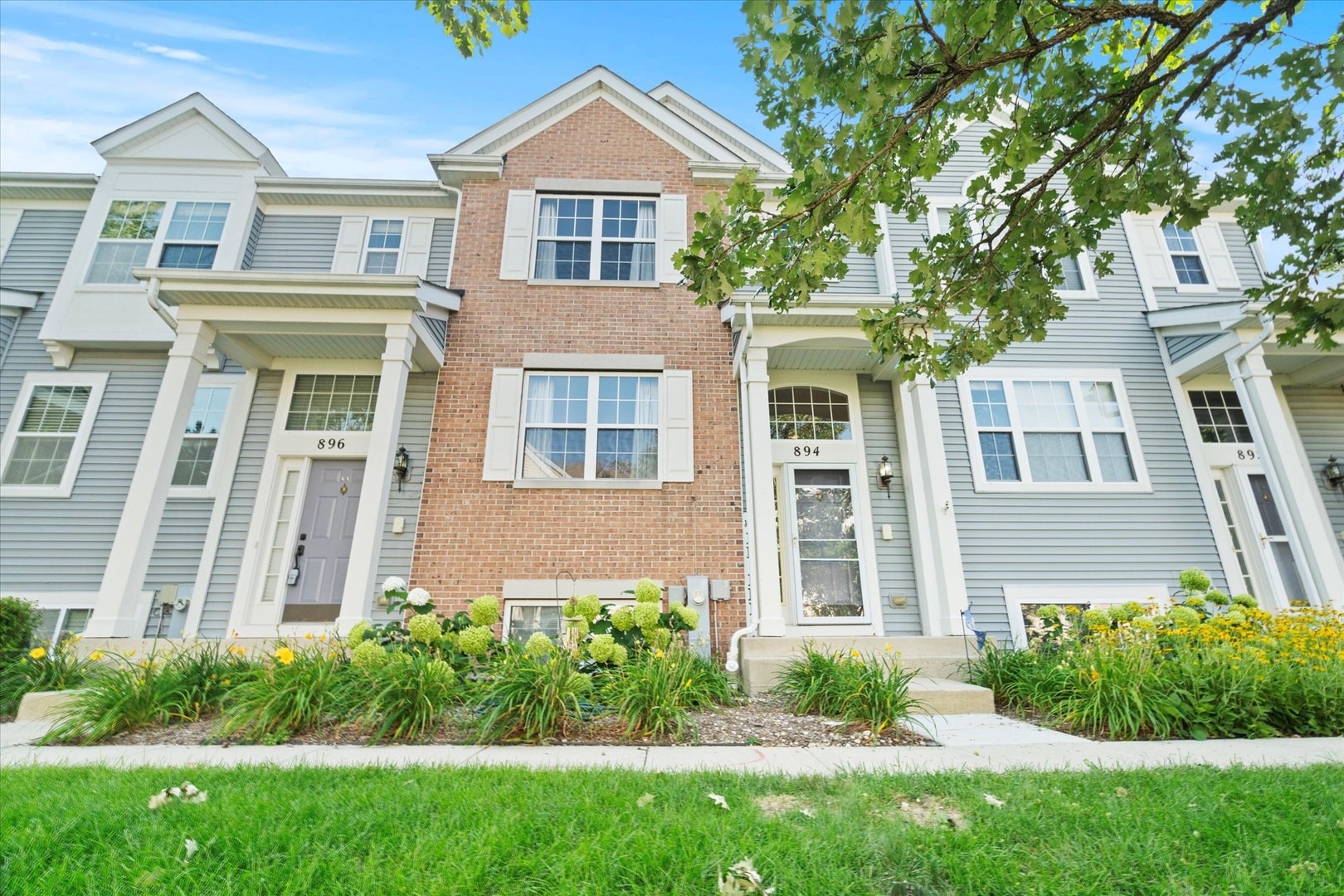 front view of a house next to a yard