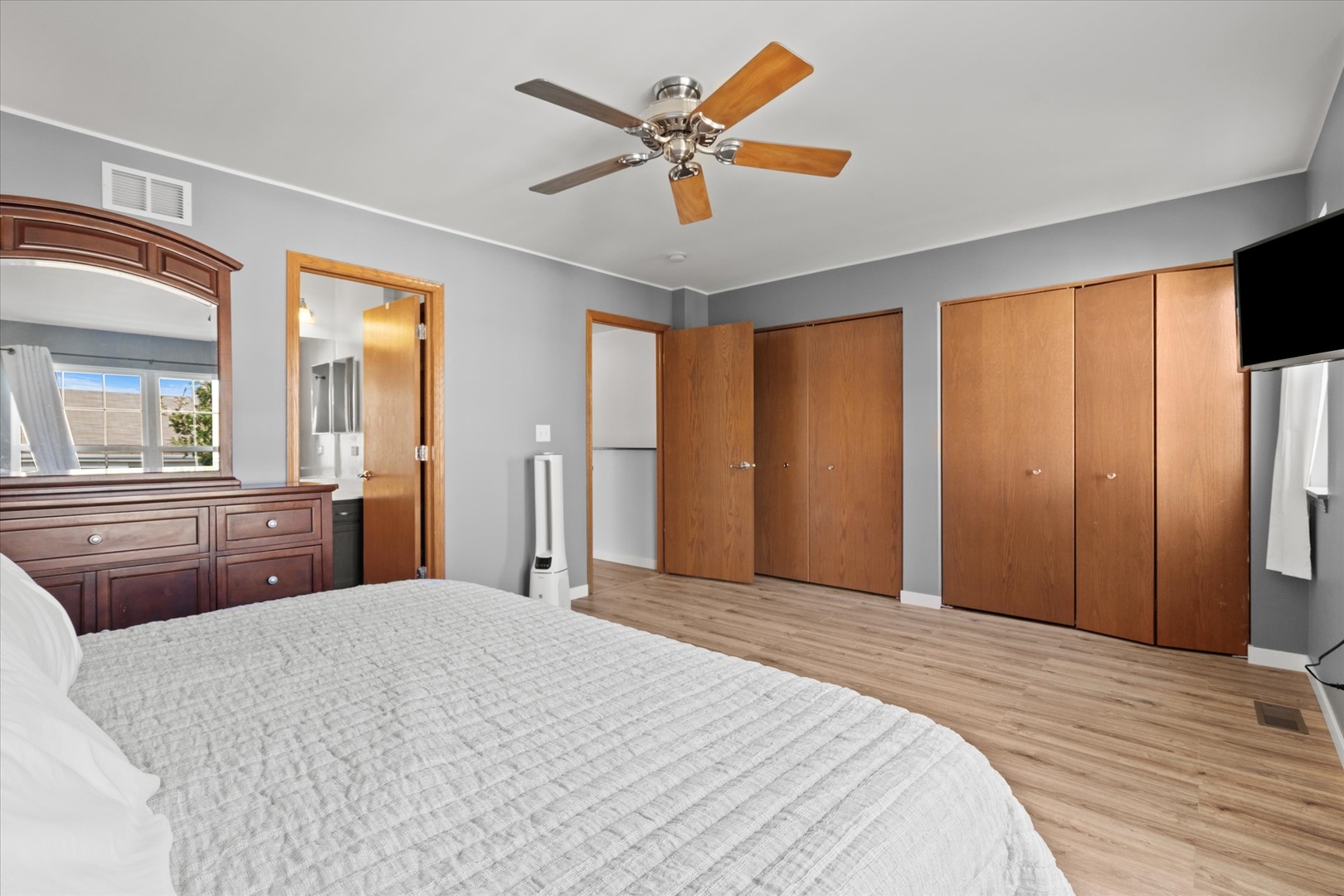 894 Clover Lane Pingree Grove, IL 60140 - Photo 11 of 24 a bedroom with a large bed and a chandelier