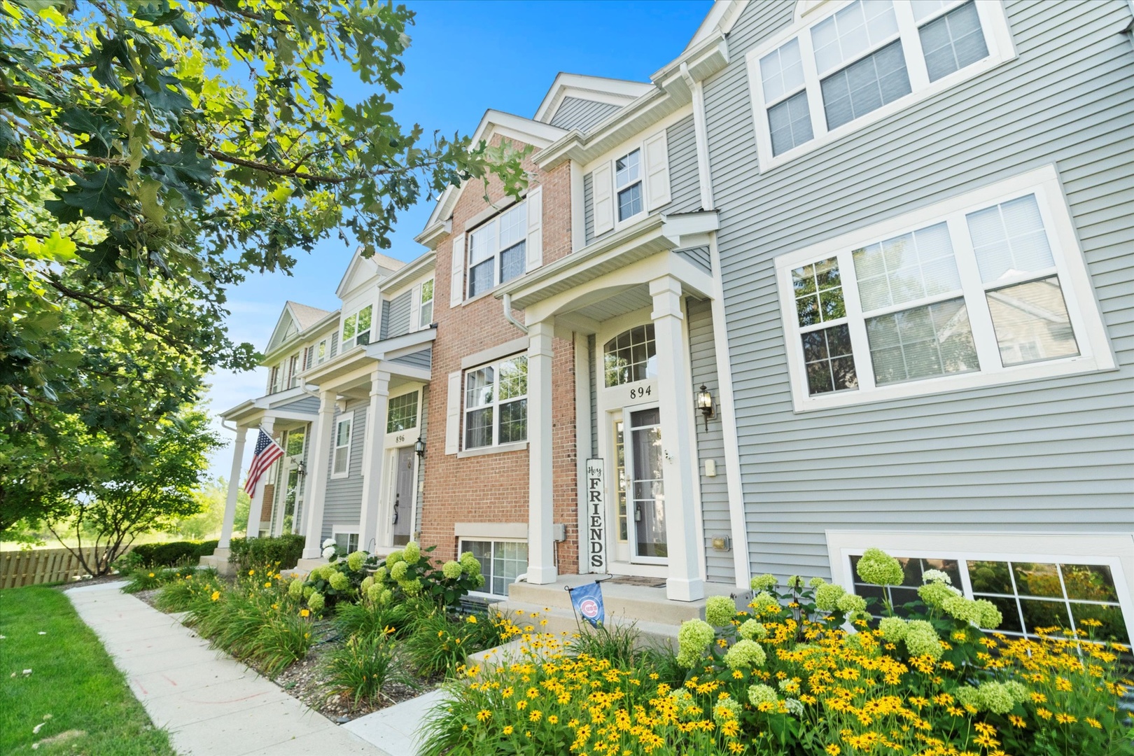 894 Clover Lane Pingree Grove, IL 60140 - Photo 2 of 24 front view of a brick house with a large windows