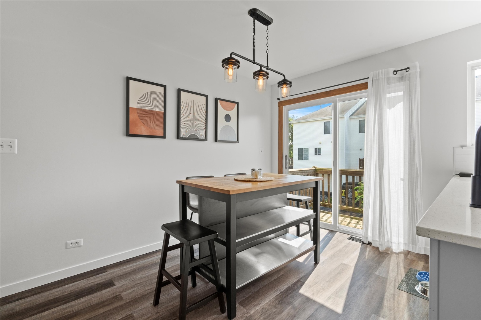 894 Clover Lane Pingree Grove, IL 60140 - Photo 7 of 24 a room with a table chairs and wooden floor