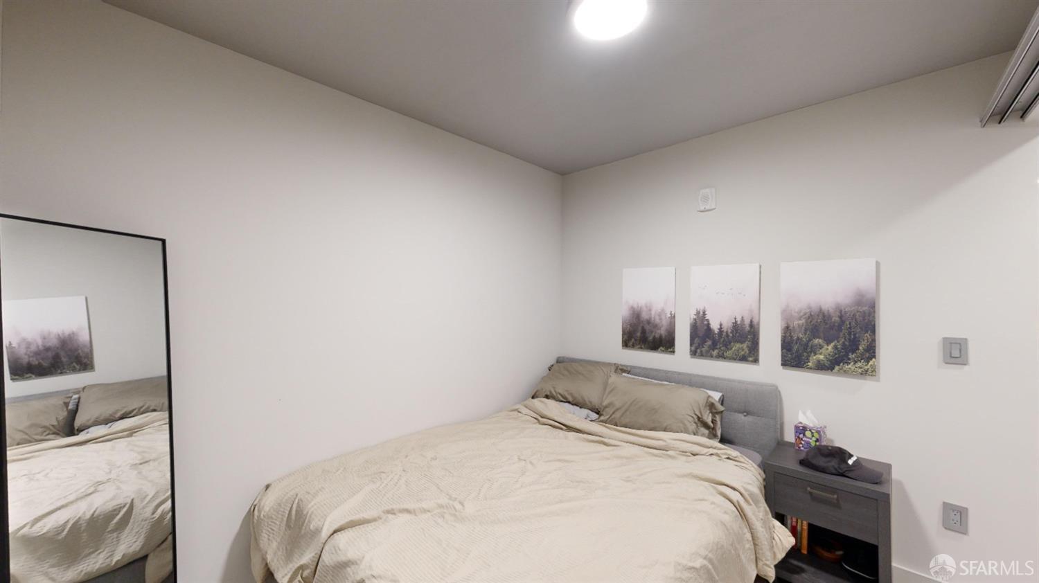 1238 Sutter Street, Unit 303 San Francisco, CA 94109 - Photo 11 of 15 a bedroom with a bed and a mirror
