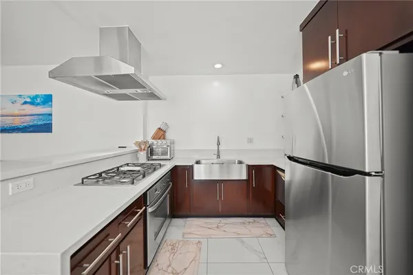 a kitchen with a sink a stove and cabinets