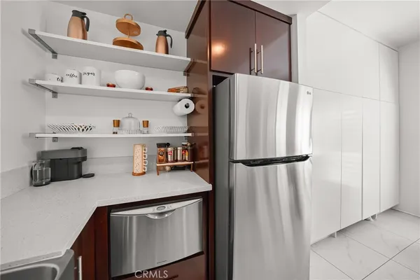 a kitchen with a table chairs and white cabinets