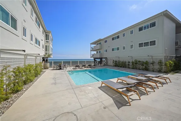 a view of a patio with table and chairs