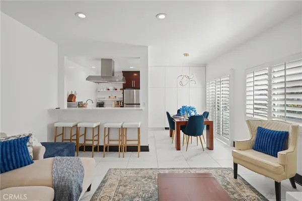 a living room with furniture a rug and a large window