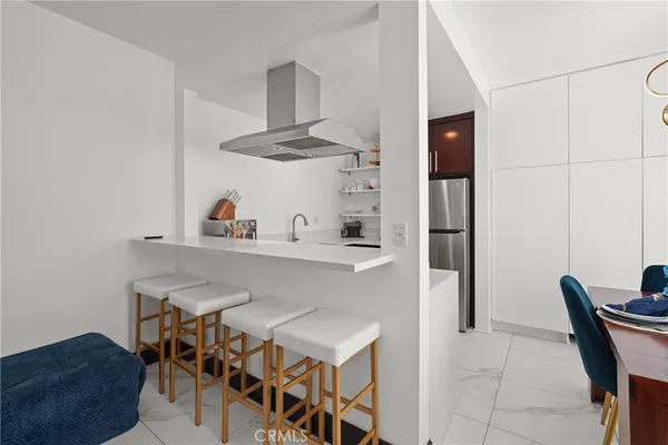 a kitchen with stainless steel appliances granite countertop a refrigerator and a stove top oven