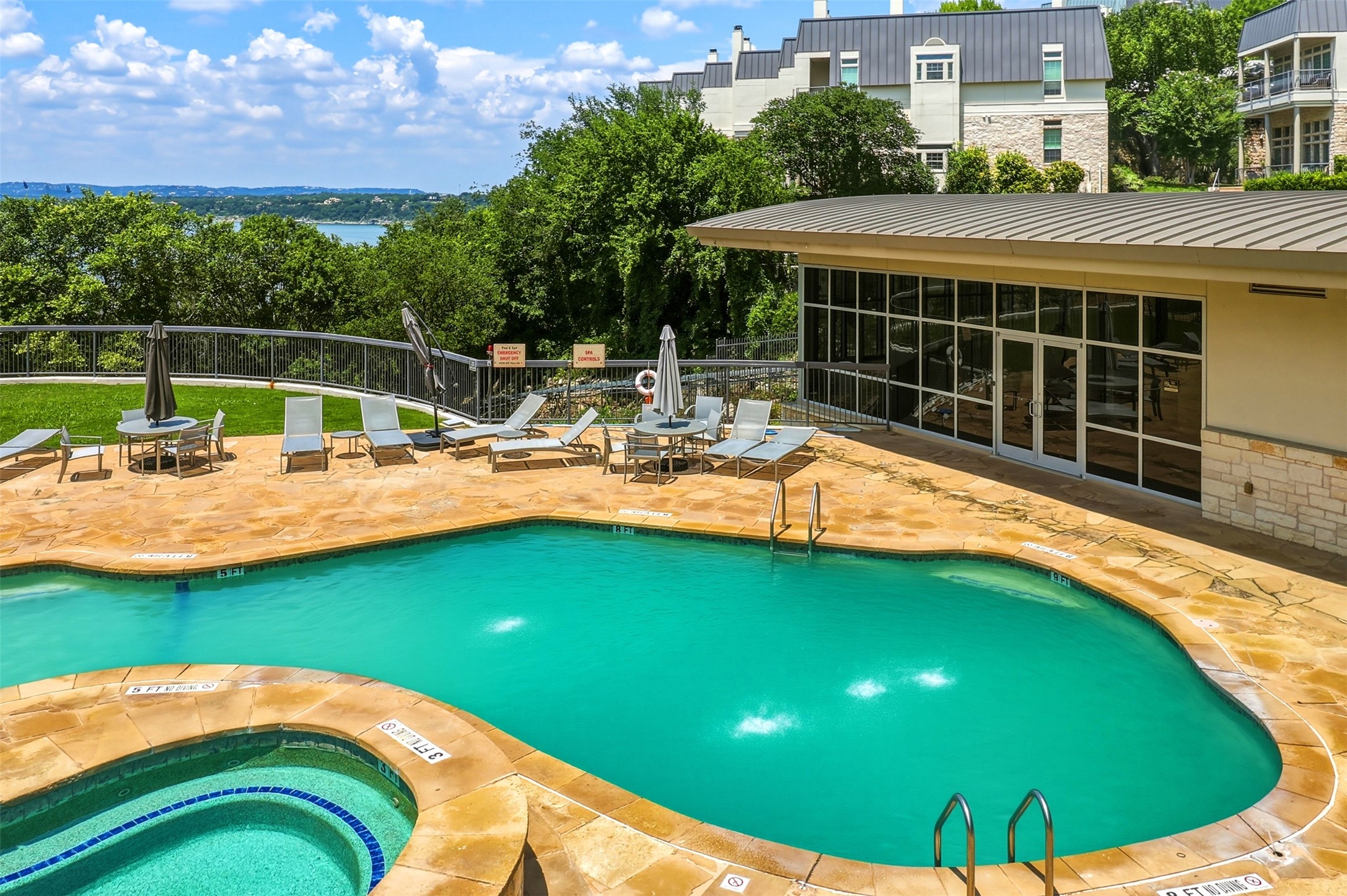 2918 Ranch Road 620, Unit 265 Austin, TX 78734 - Photo 29 of 40 A tranquil pool and spa area with panoramic lake and hill views for ultimate relaxation.