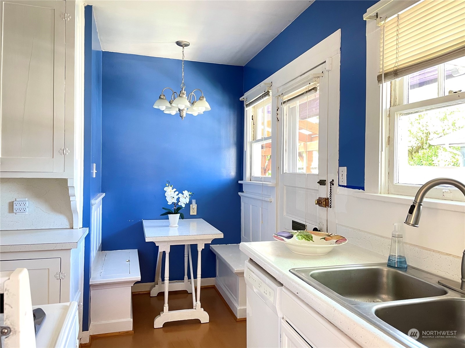 825 Northeast 63rd Street Seattle, WA 98115 - Photo 4 of 12 a kitchen with a dining table chairs and a chandelier