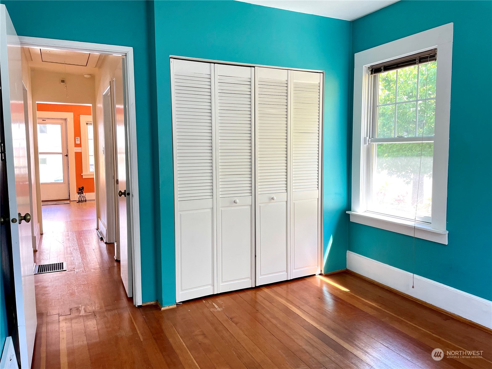 825 Northeast 63rd Street Seattle, WA 98115 - Photo 8 of 12 an empty room with wooden floor and windows