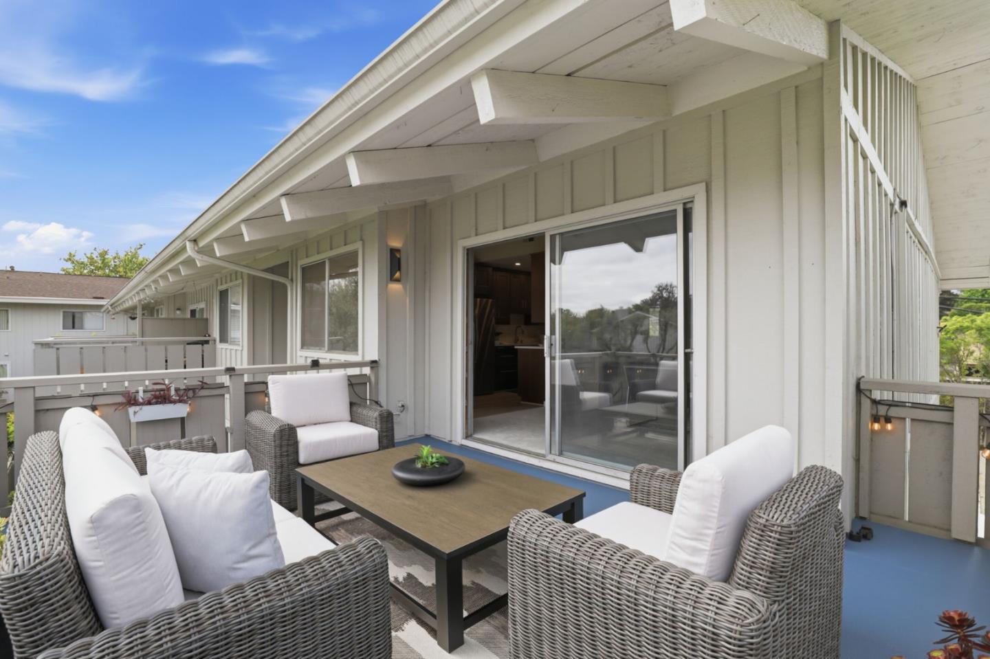 255 South Rengstorff Avenue, Unit 2 Mountain View, CA 94040 - Photo 5 of 25 a balcony with furniture and glass door