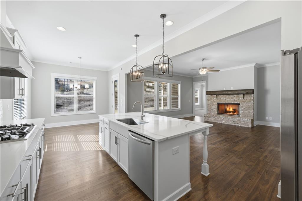 5706 Meadow View Drive Jefferson, GA 30549 - Photo 16 of 47 a kitchen with a stove a sink a center island and windows
