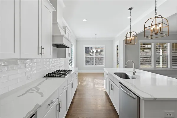 a kitchen with granite countertop a sink stove and cabinets