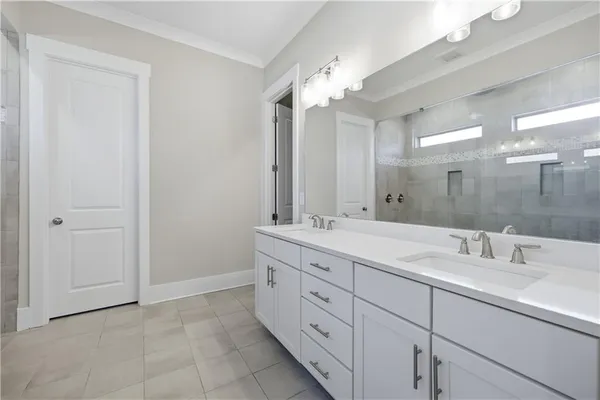 a bathroom with a double vanity sink mirror and
