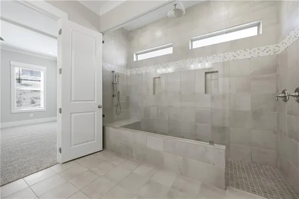 a bathroom with a bathtub and shower