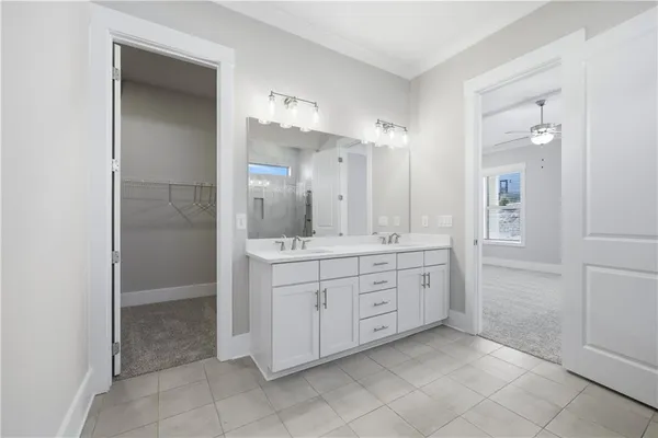 a spacious bathroom with a mirror a shower and a sink