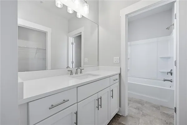 a bathroom with a sink a vanity and a mirror
