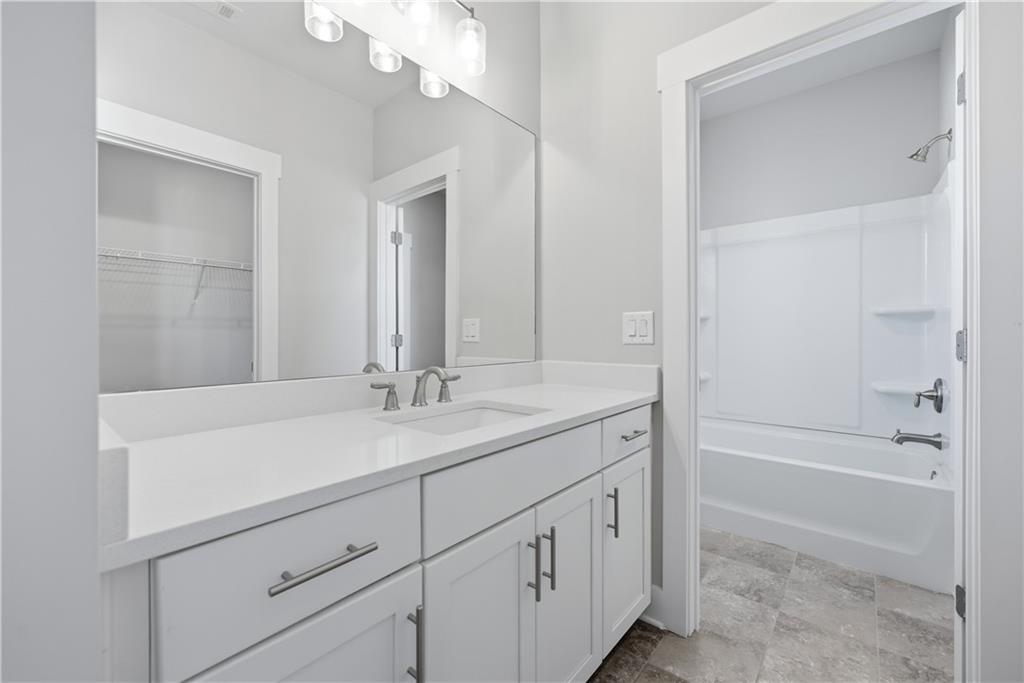 5706 Meadow View Drive Jefferson, GA 30549 - Photo 38 of 47 a bathroom with a sink a vanity and a mirror