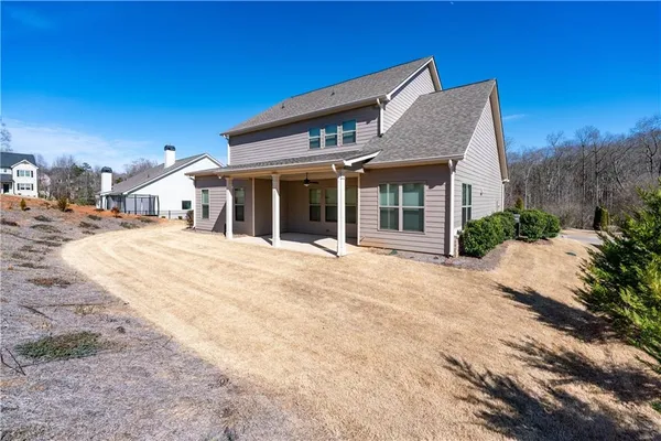 a front view of a house with a garden
