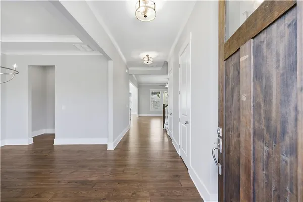 a view of a hallway with wooden floor
