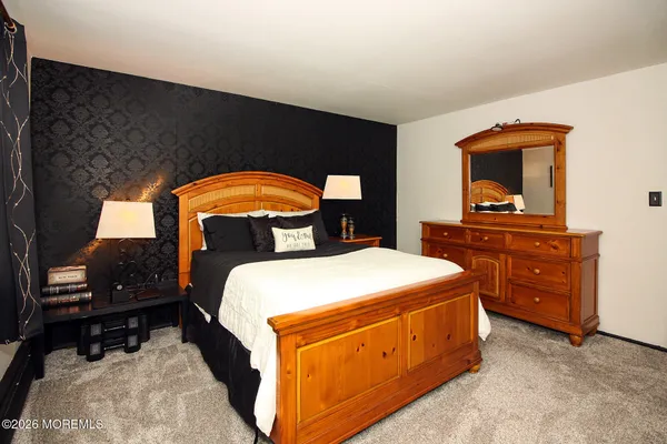 a bedroom with a bed and a dresser