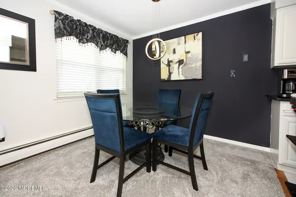 a view of a dining room with furniture and window