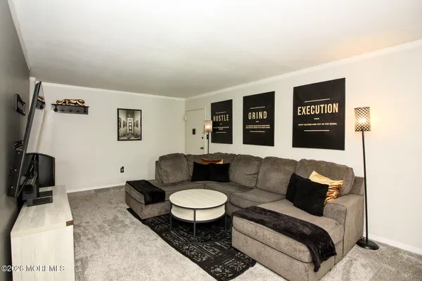 a living room with furniture and a rug