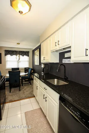 a kitchen with granite countertop lots of counter top space and stainless steel appliances