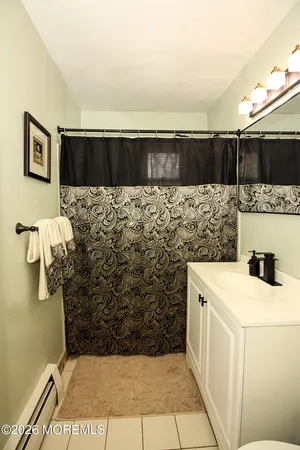 a bathroom with a sink a mirror and shower