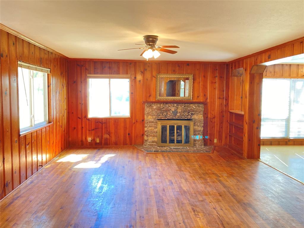 11655 Randle Lane Fort Worth, TX 76179 - Photo 21 of 35 a view of a livingroom with wooden floor a fireplace and windows