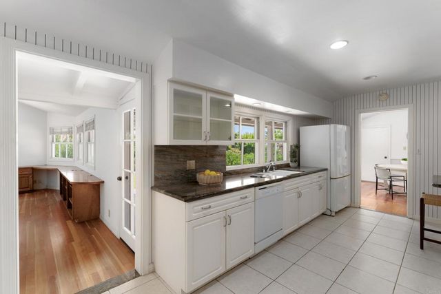 a kitchen with stainless steel appliances granite countertop a refrigerator and a sink