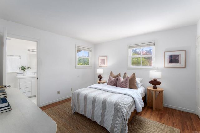 a bedroom with a bed and a view of kitchen
