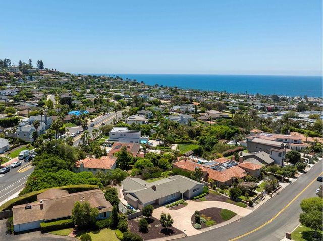 an aerial view of residential houses with city view