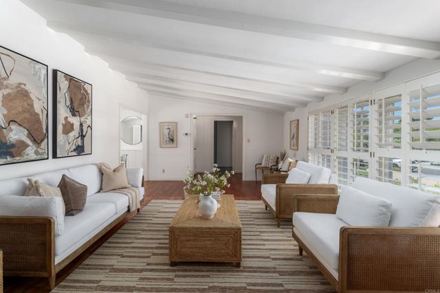 a living room with furniture or couch and a wooden floor