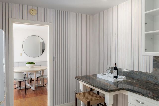 a bathroom with a granite countertop sink a mirror and a toilet