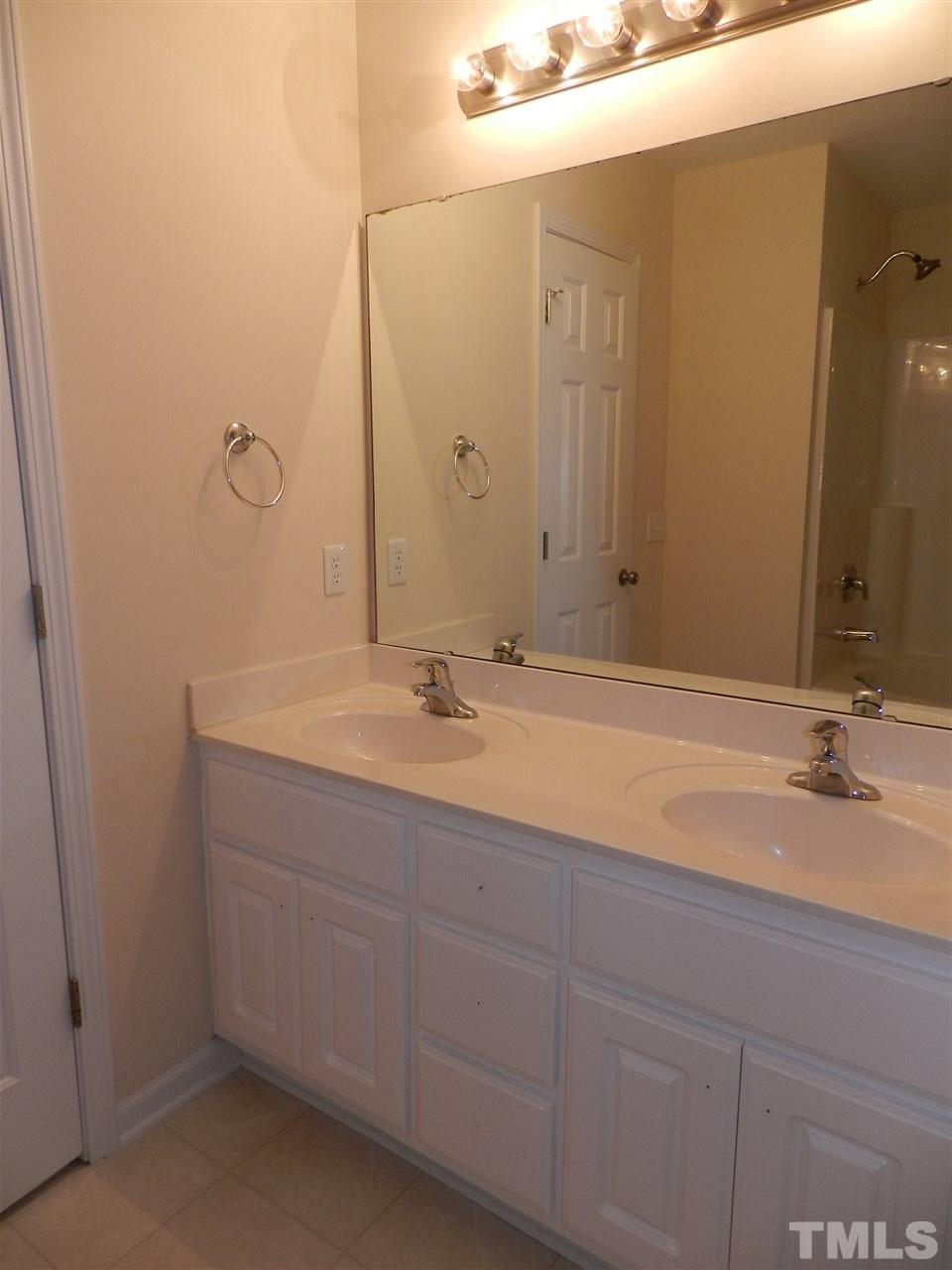 453 Axum Road Willow Spring, NC 27592 - Photo 12 of 17 a bathroom with a sink and a mirror
