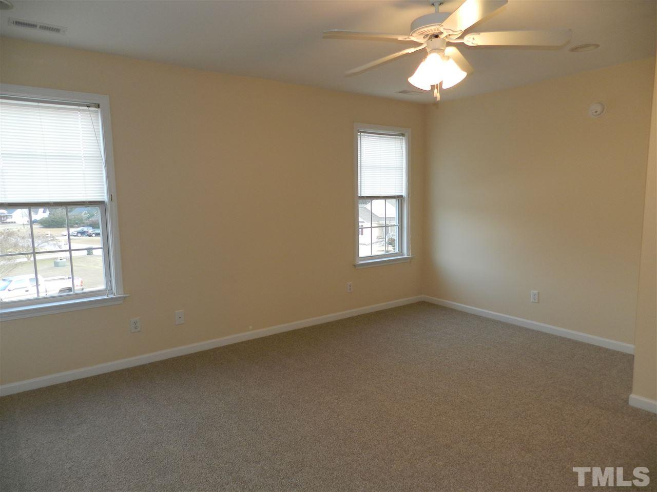 453 Axum Road Willow Spring, NC 27592 - Photo 13 of 17 an empty room with windows and fan