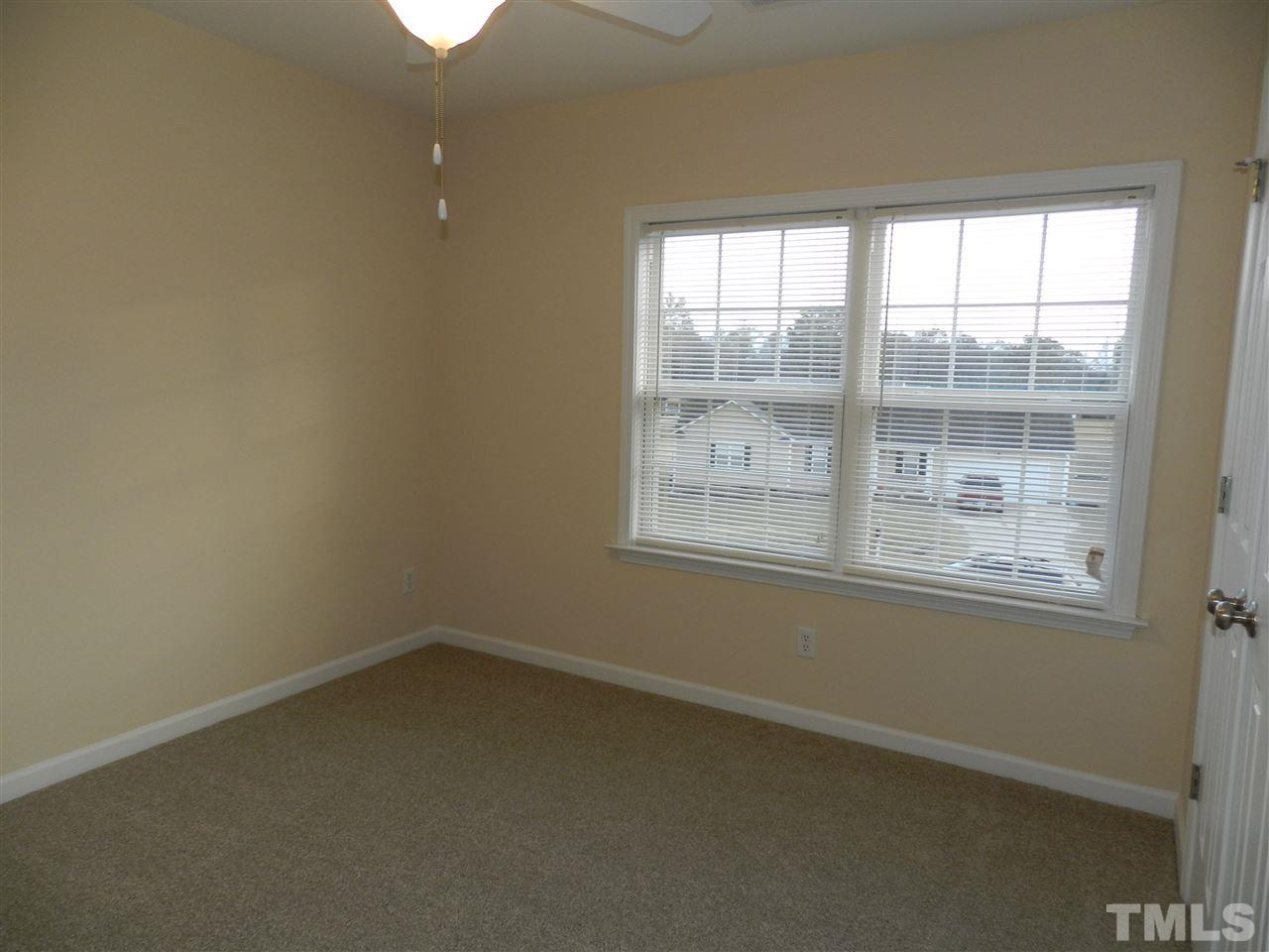 453 Axum Road Willow Spring, NC 27592 - Photo 14 of 17 an empty room with a window
