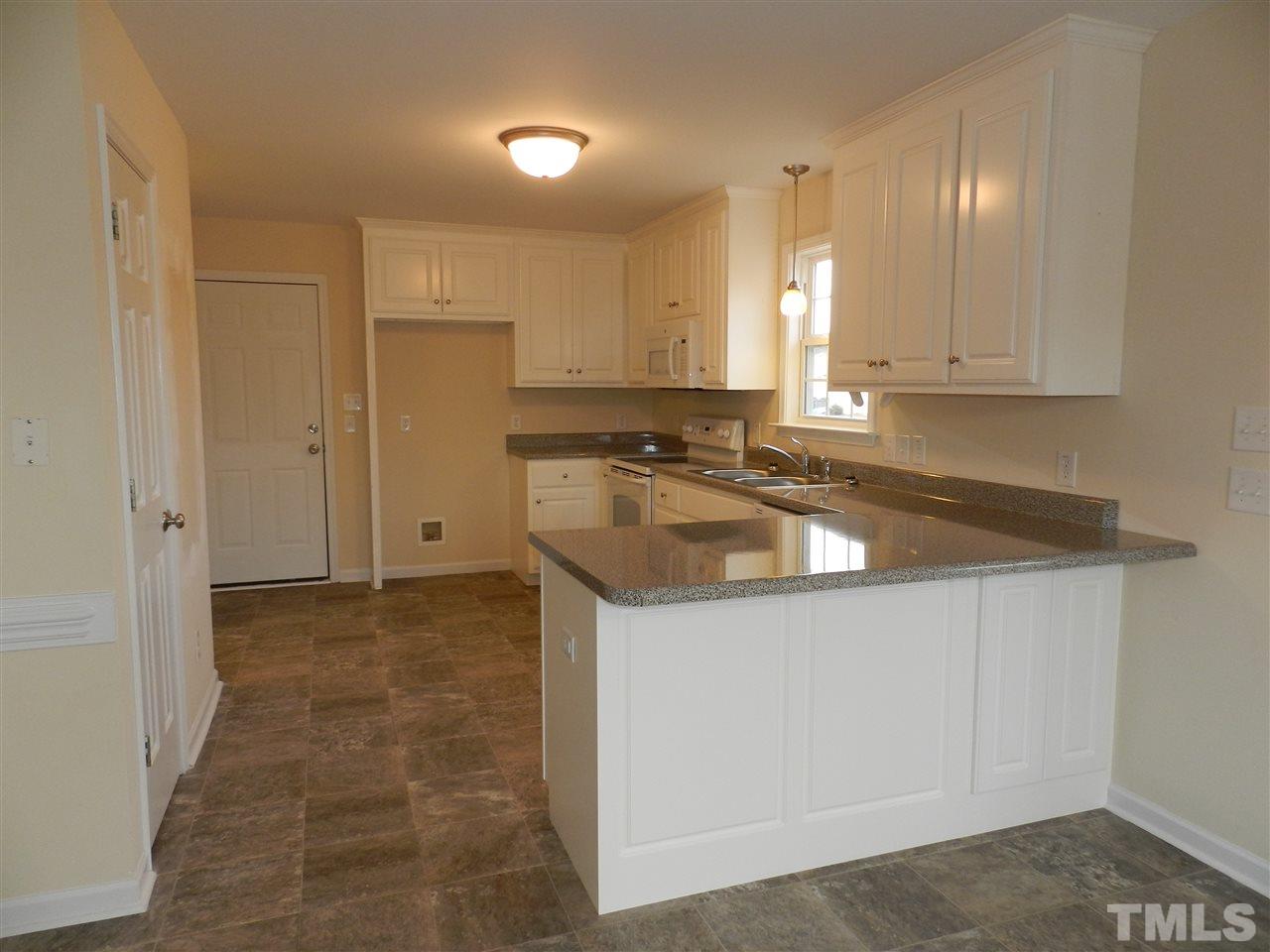 453 Axum Road Willow Spring, NC 27592 - Photo 8 of 17 a kitchen that has a sink and a stove