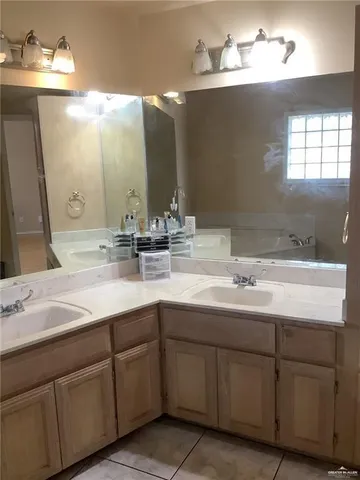 a bathroom with a double vanity sink and a mirror
