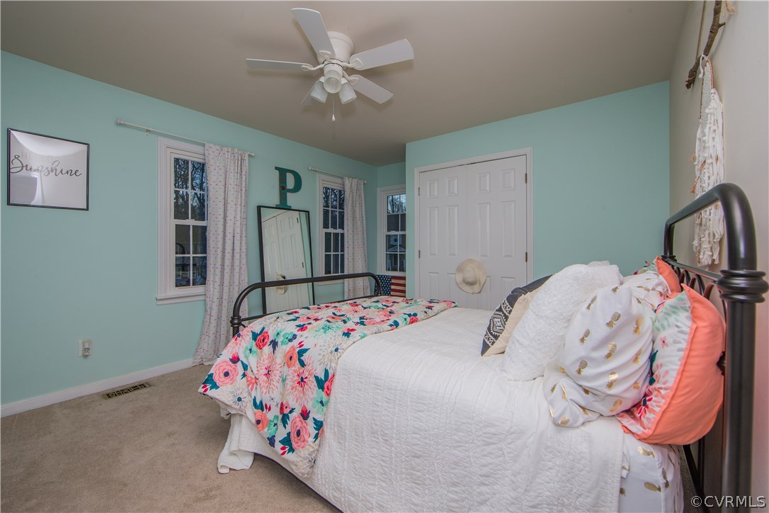 13810 Laurel Spring Road Chester, VA 23831 - Photo 26 of 28 a bedroom with a bed and dresser with mirror