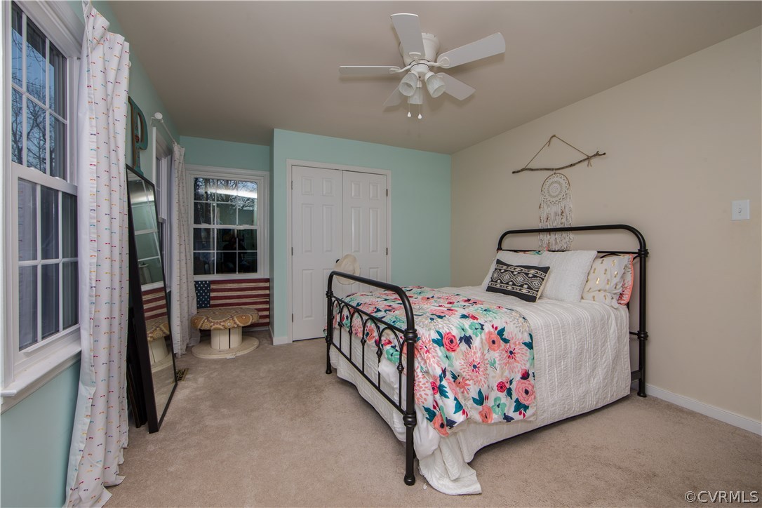 13810 Laurel Spring Road Chester, VA 23831 - Photo 27 of 28 a bedroom with a bed and a chandelier