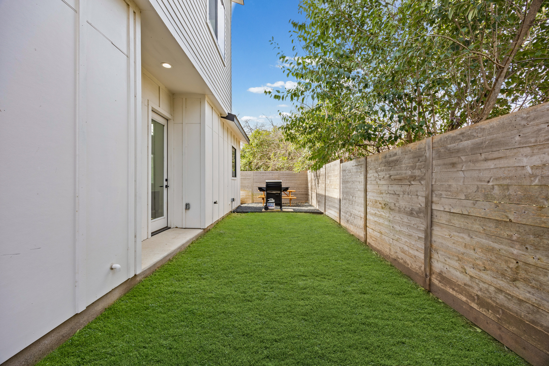 7102 Providence Avenue, Unit 2 Austin, TX 78752 - Photo 19 of 22 a view of a backyard with table and a chairs