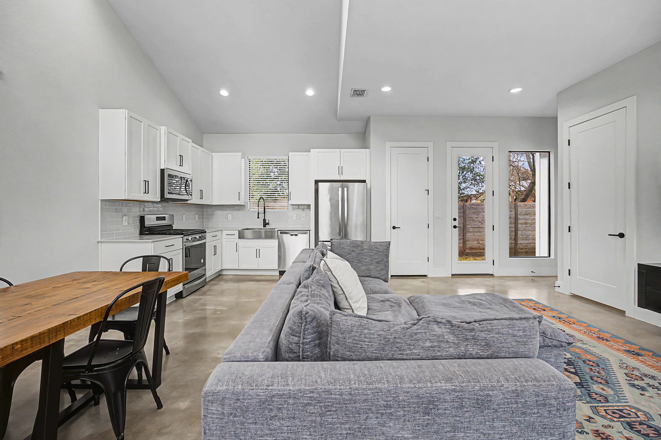 7102 Providence Avenue, Unit 2 Austin, TX 78752 - Photo 3 of 22 a living room with stainless steel appliances granite countertop furniture and a couch