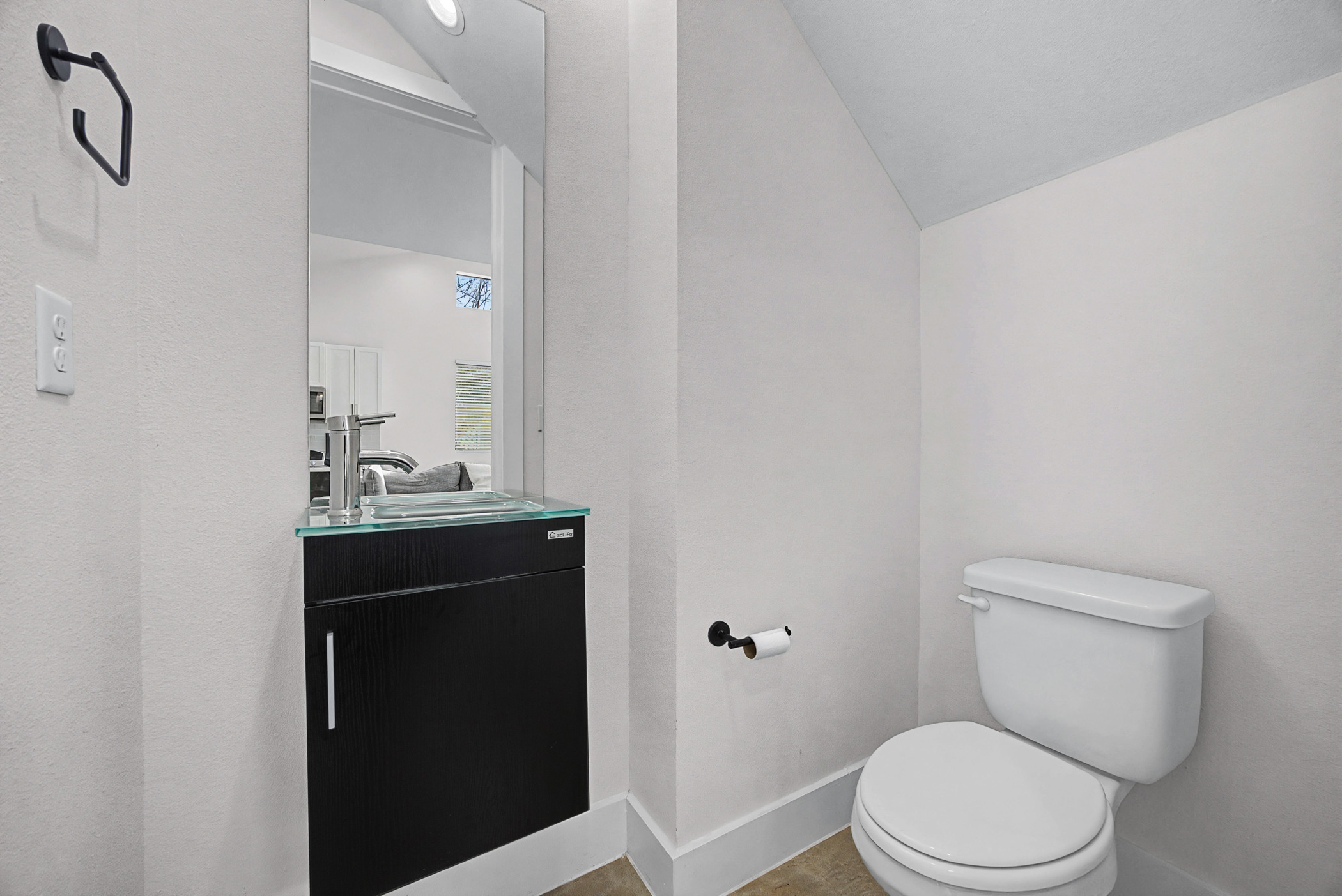 7102 Providence Avenue, Unit 2 Austin, TX 78752 - Photo 9 of 22 a bathroom with a toilet a sink and mirror