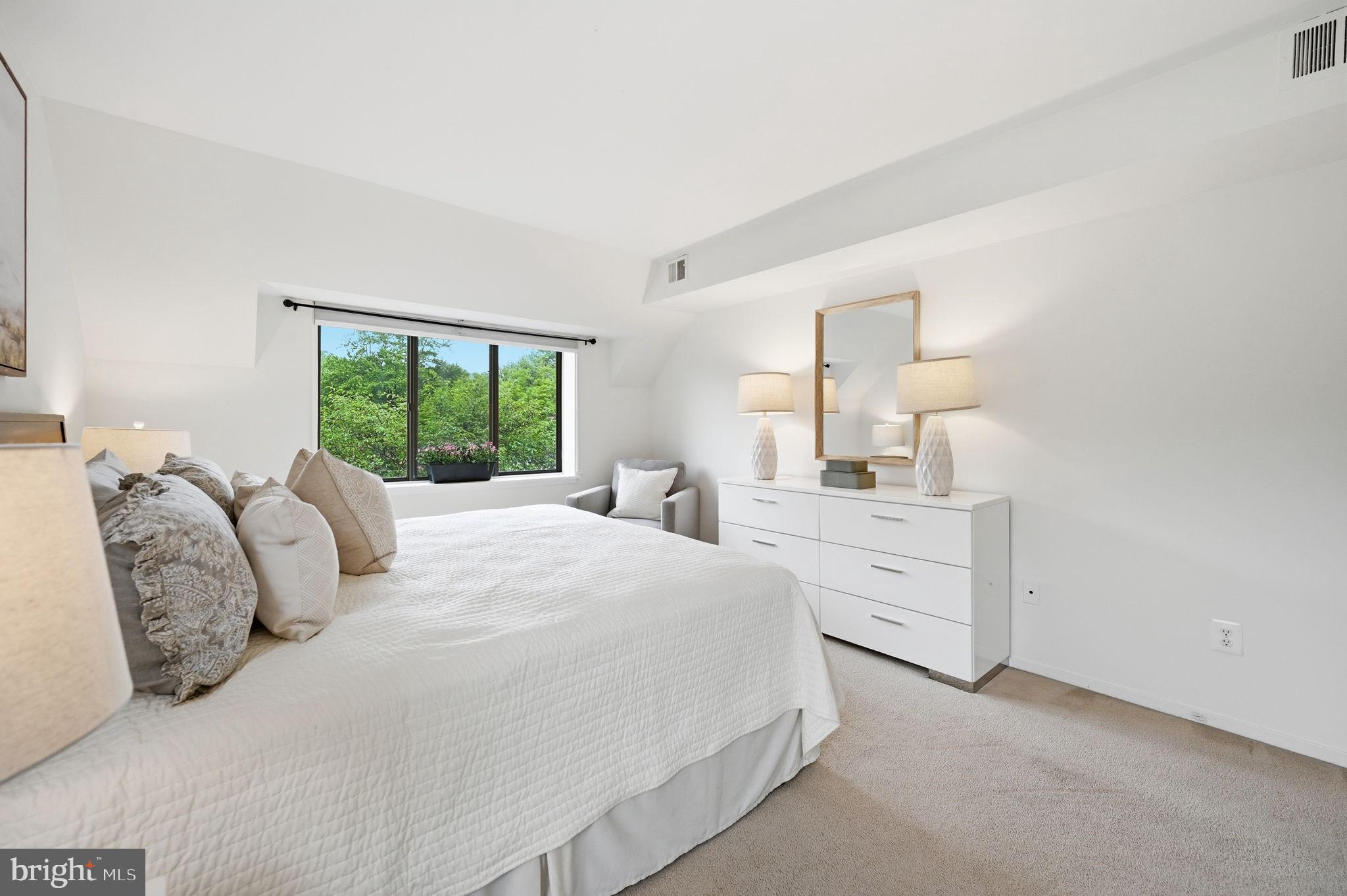 1659 Parkcrest Circle, Unit C Reston, VA 20190 - Photo 22 of 31 a bedroom with a large bed and a dresser