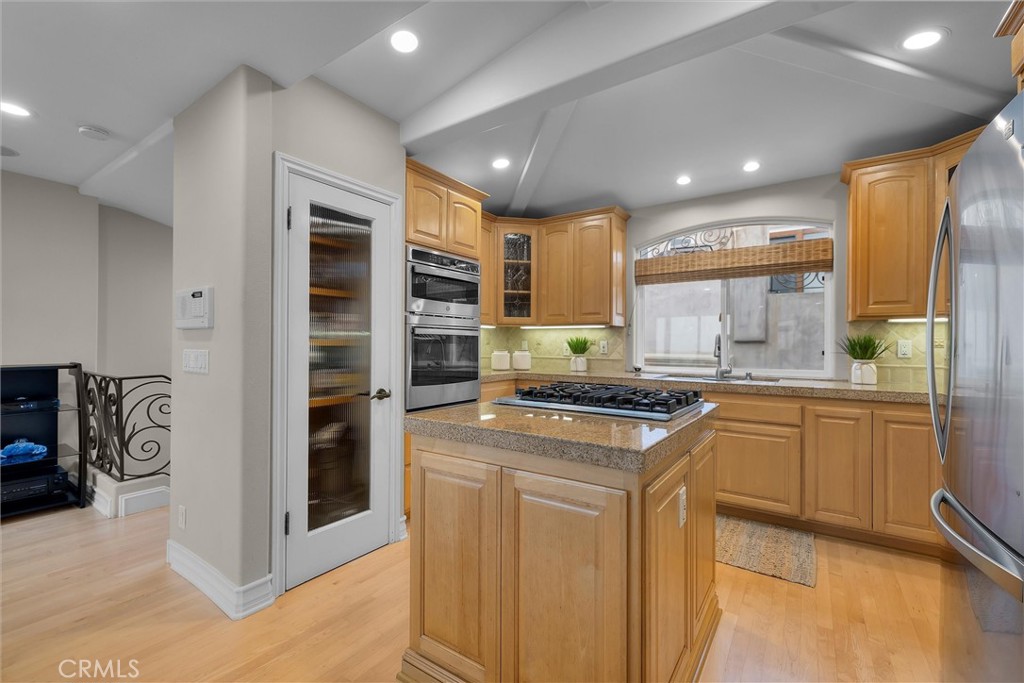 1042 Bayview Drive Hermosa Beach, CA 90254 - Photo 15 of 44 a kitchen with stainless steel appliances granite countertop a stove a sink and a refrigerator