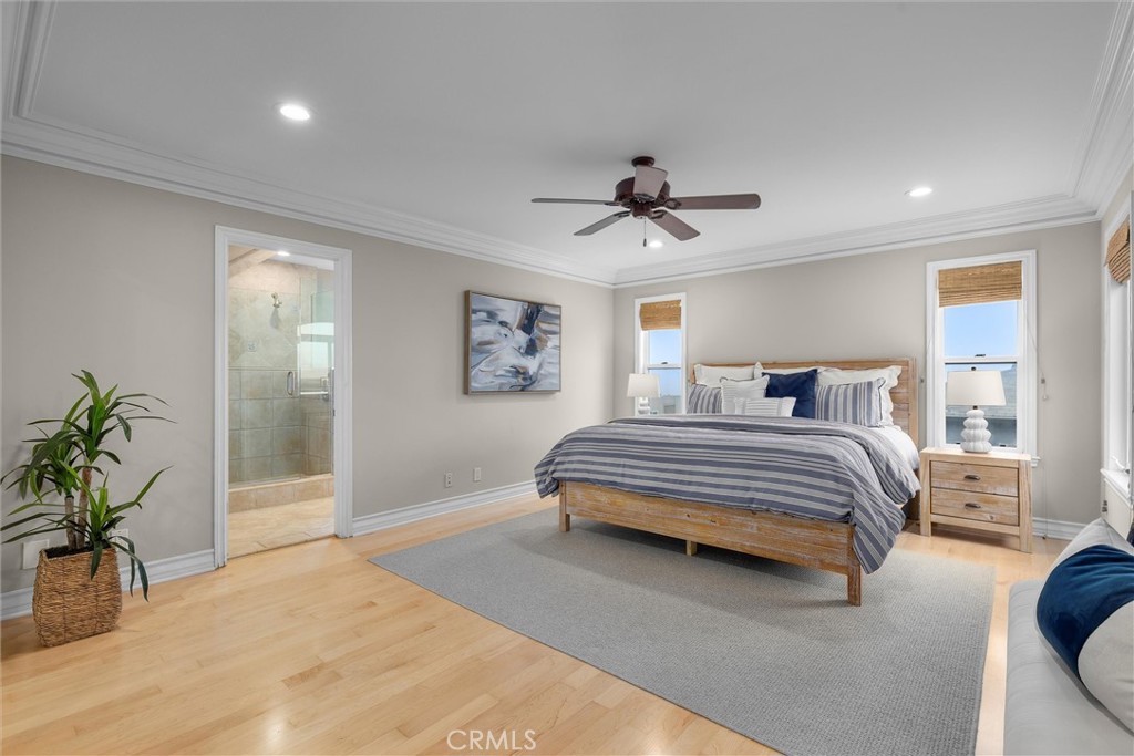 1042 Bayview Drive Hermosa Beach, CA 90254 - Photo 21 of 44 a bedroom with a large bed a potted plant and a dresser